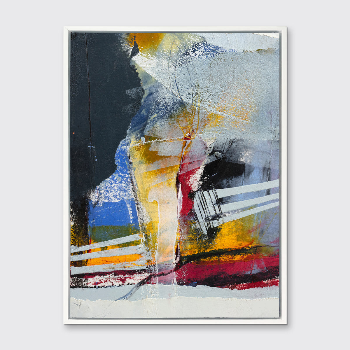 A white, yellow, red and grey abstract print in a white floater frame hangs on a white wall.