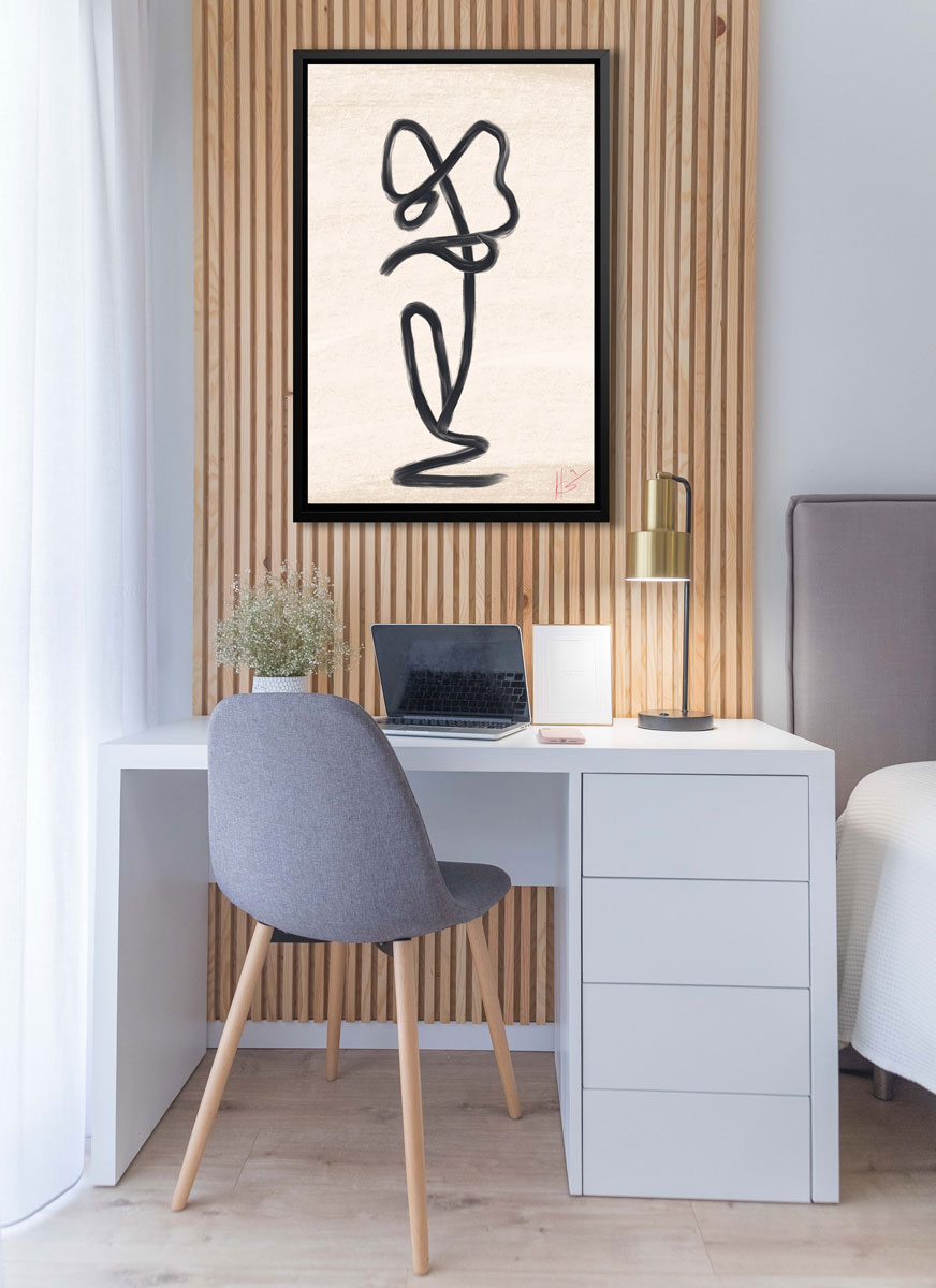 A black minimalistic art print hangs on a bamboo wall above a modern desk. 