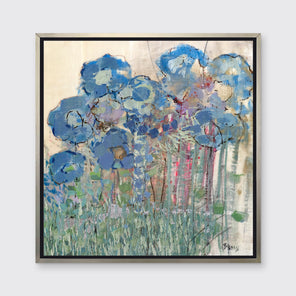 A blue and green abstract floral print in a silver floater frame hangs on a white wall.