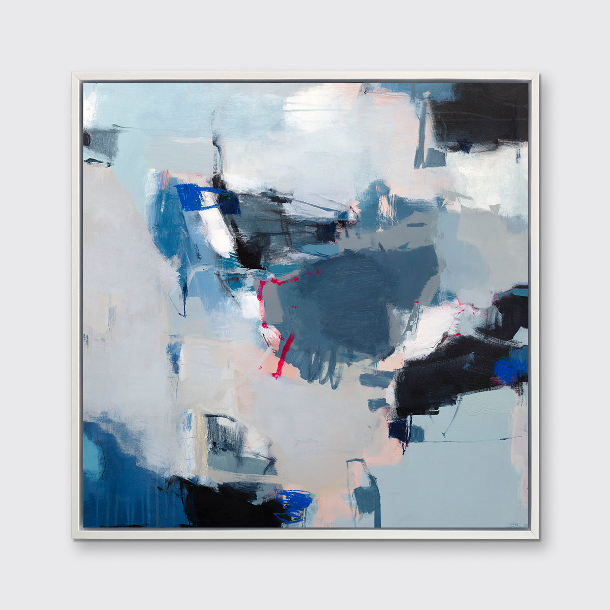 A blue, white and black abstract print in a white floater frame hangs on a white wall.