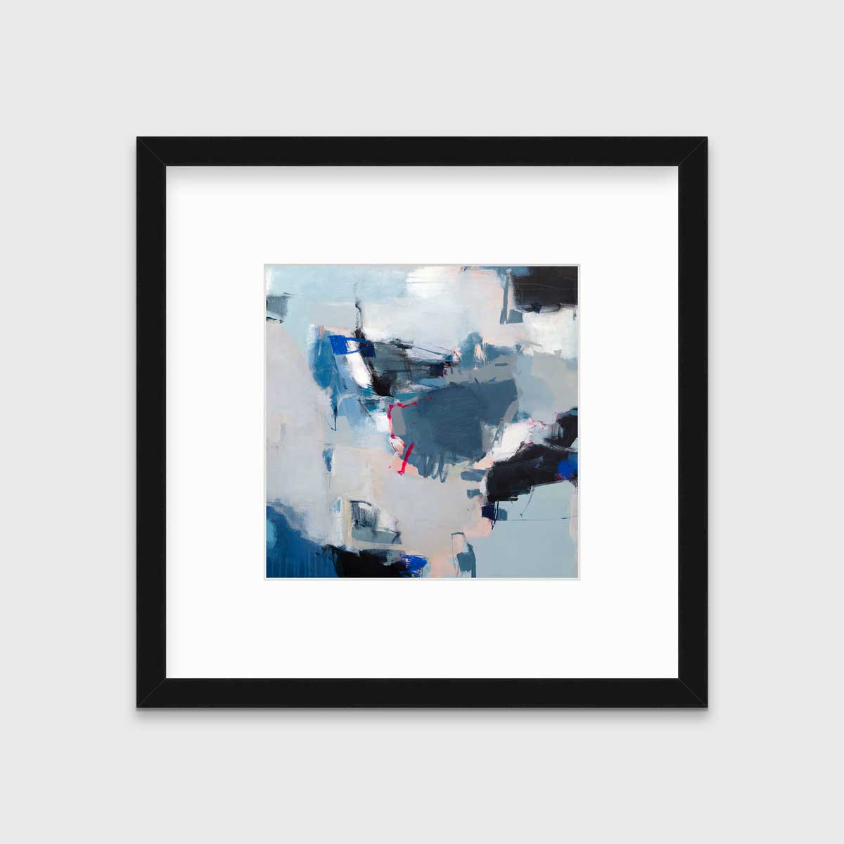 A blue abstract print by Kelly Rossetti in a black frame with a mat hangs on a white wall.