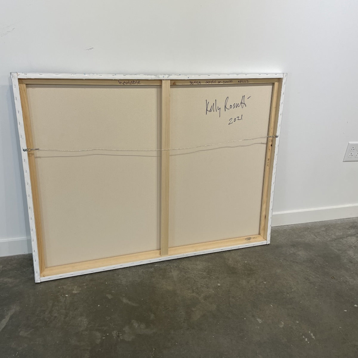 A photo of the back of a painting by Kelly Rosetti.