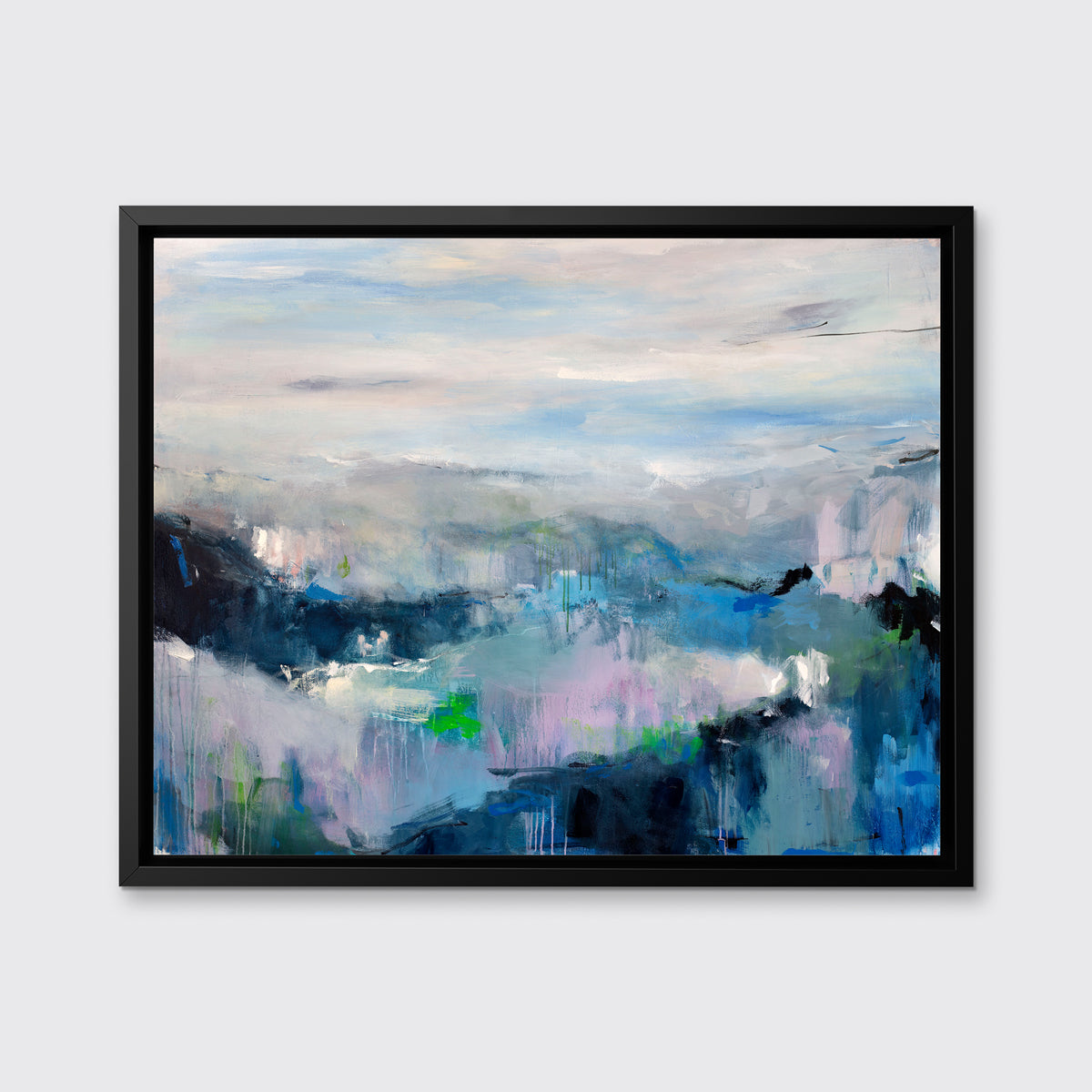 A blue, purple and green abstract print in a black floater frame hangs on a white wall.