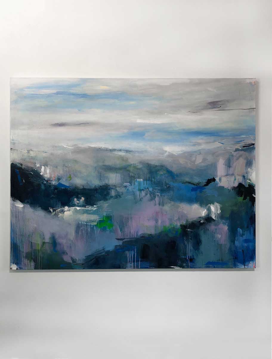 A blue, white and green abstract landscape painting hangs on a white wall.