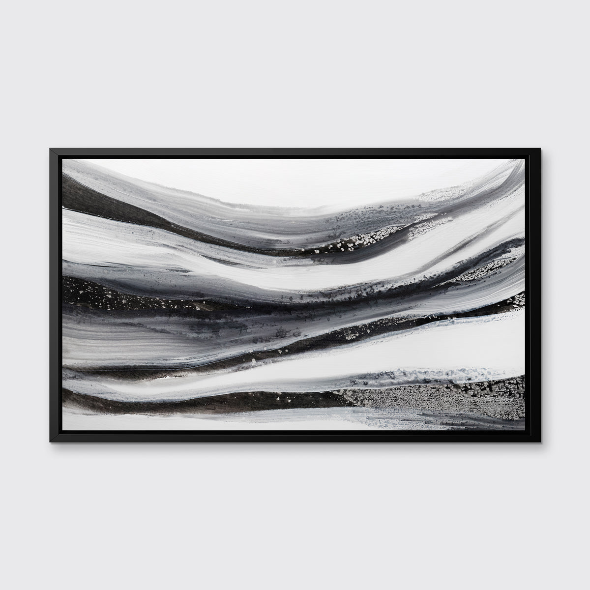 A black, white and grey abstract print in a black floater frame hangs on a white wall.