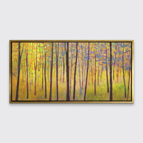 A yellow abstract tree landscape print in a gold floater frame hangs on a white wall.
