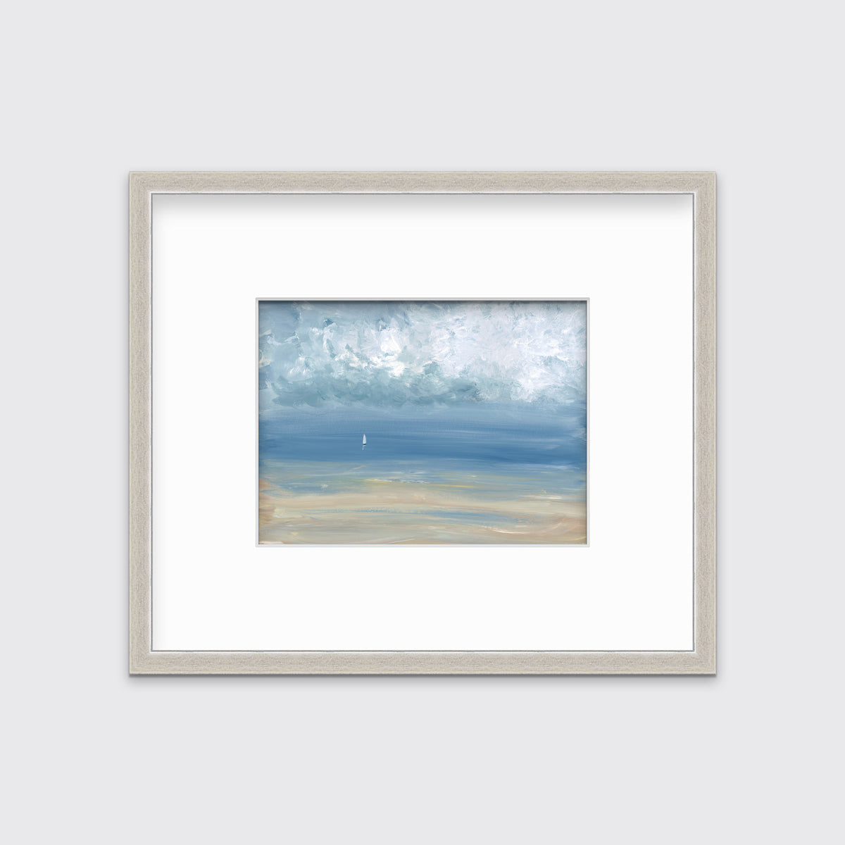 A white, blue and beige abstract seascape print in a silver frame with a mat hangs on a white wall.