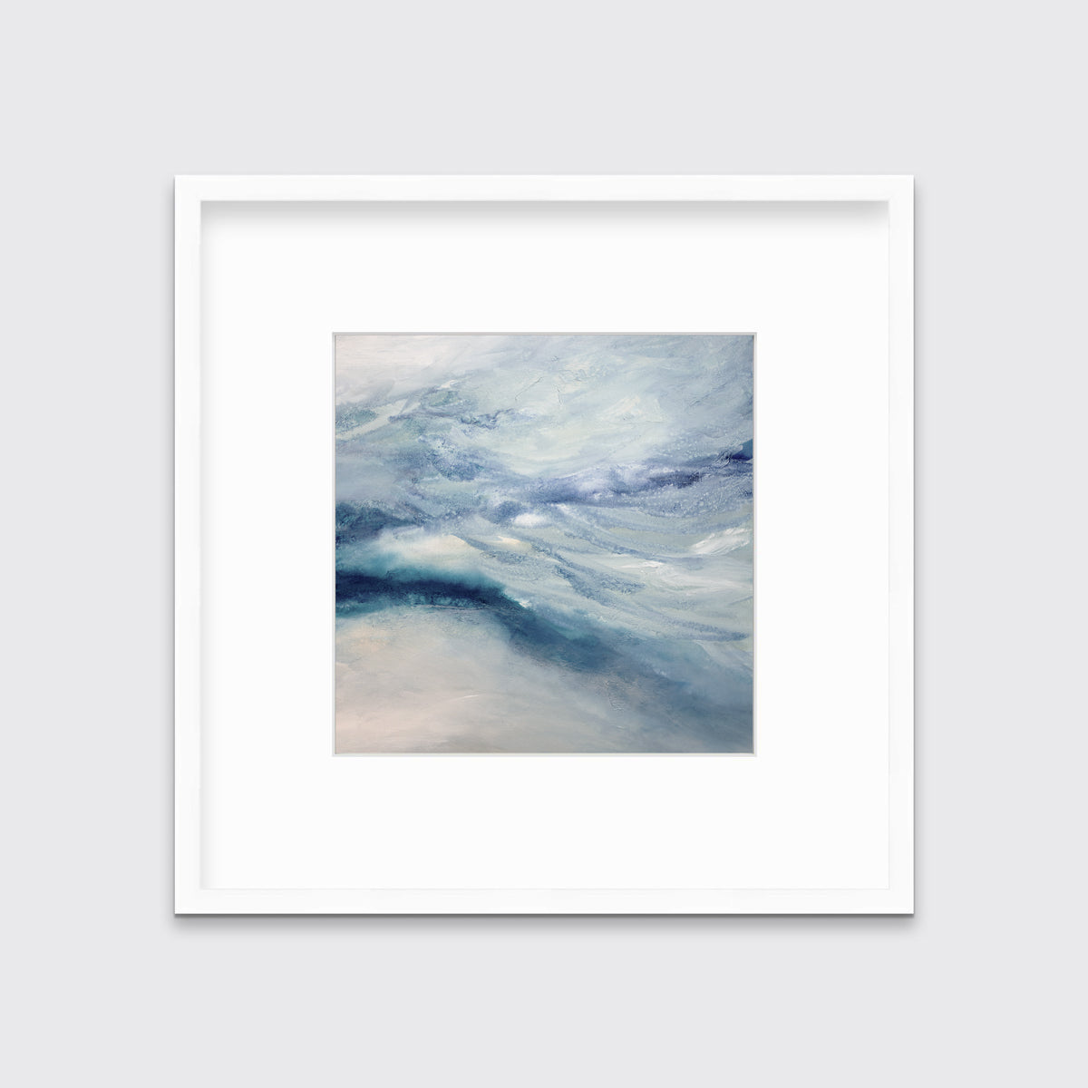 A blue, white, teal and light purple abstract print in a white frame with a mat hangs on a white wall.