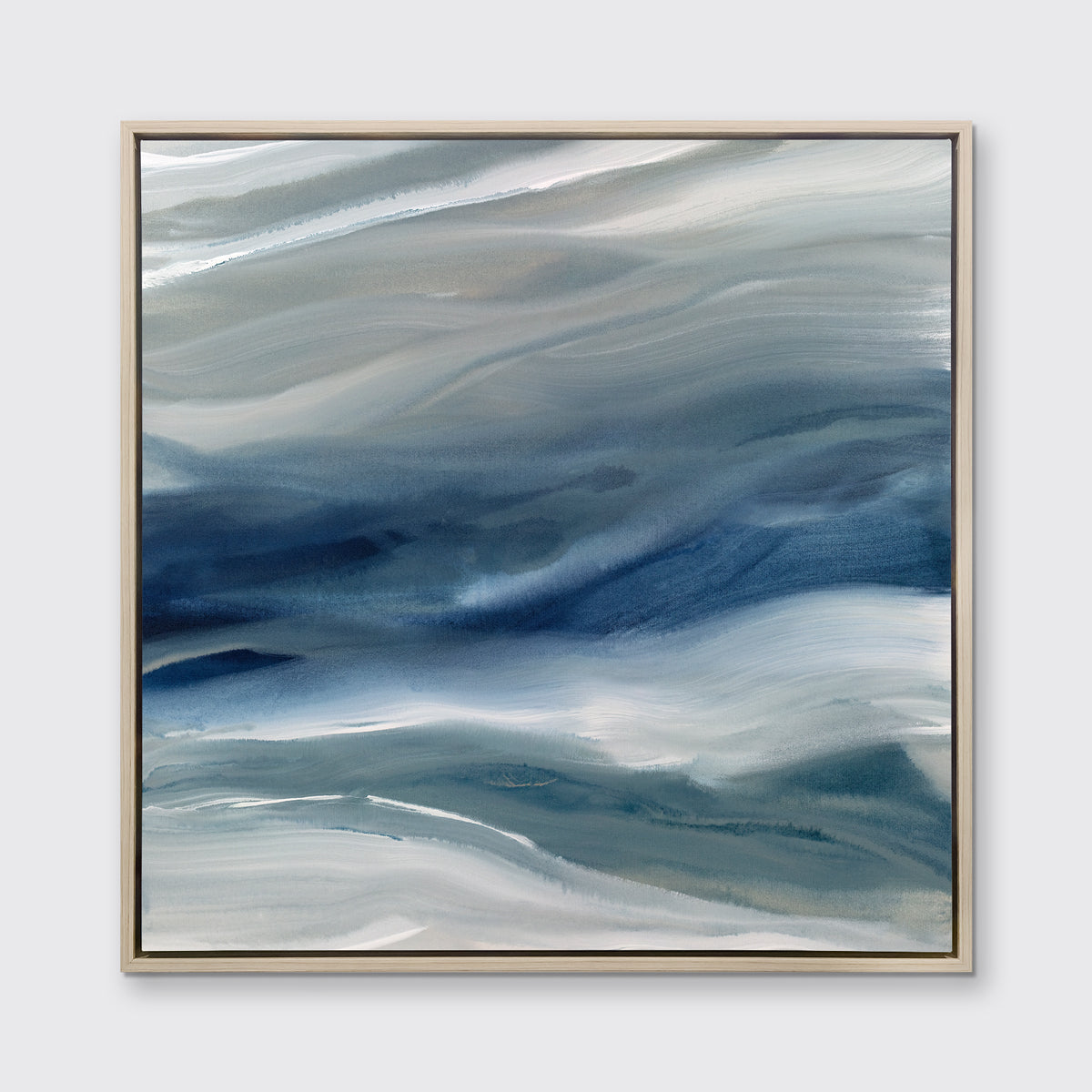 A blue, teal, beige and white abstract print in a white oak wood floater frame hangs on a white wall.