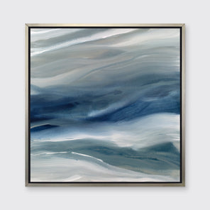 A blue, teal, beige and white abstract print in a silver floater frame hangs on a white wall.