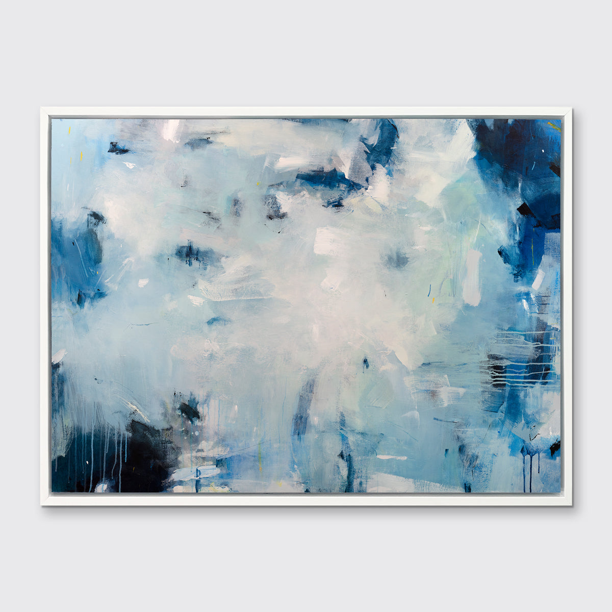 A blue, white and black abstract print in a white floater frame hangs on a white wall.