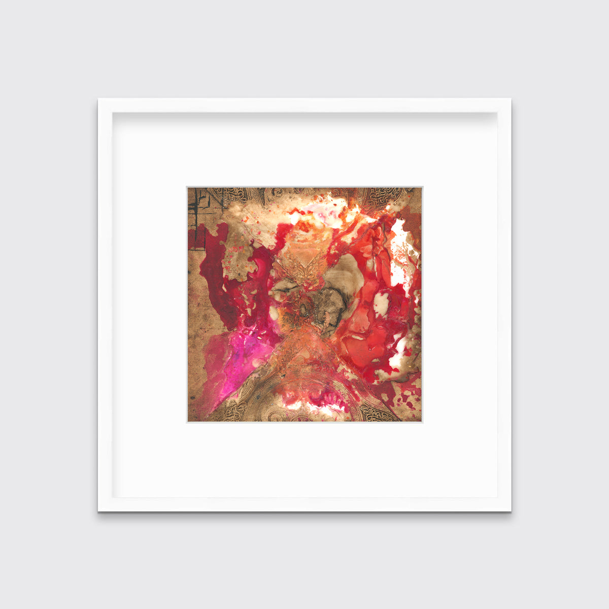 A gold, red and pink abstract print in a white frame with a mat hangs on a white wall.