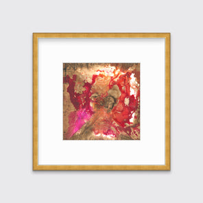 A gold, red and pink abstract print in a gold frame with a mat hangs on a white wall.