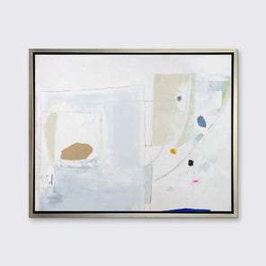 A white, blue, beige and light green abstract print in a silver floater frame hangs on a white wall.