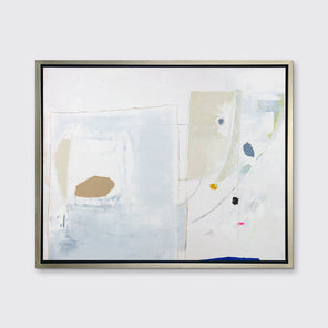 A white, blue, beige and light green abstract print in a silver floater frame hangs on a white wall.