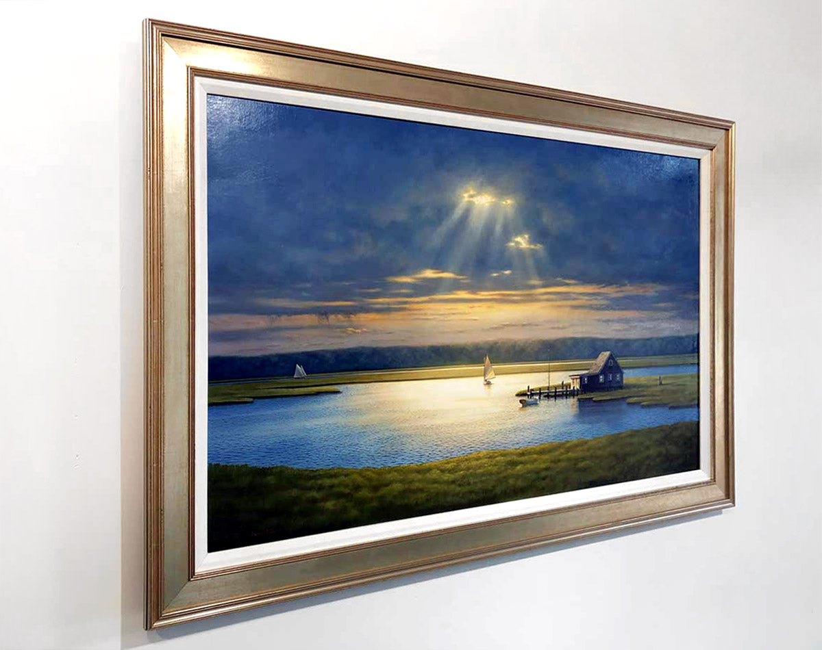 A left side-angled image of "Into the Light" in a gold frame and on a white wall.