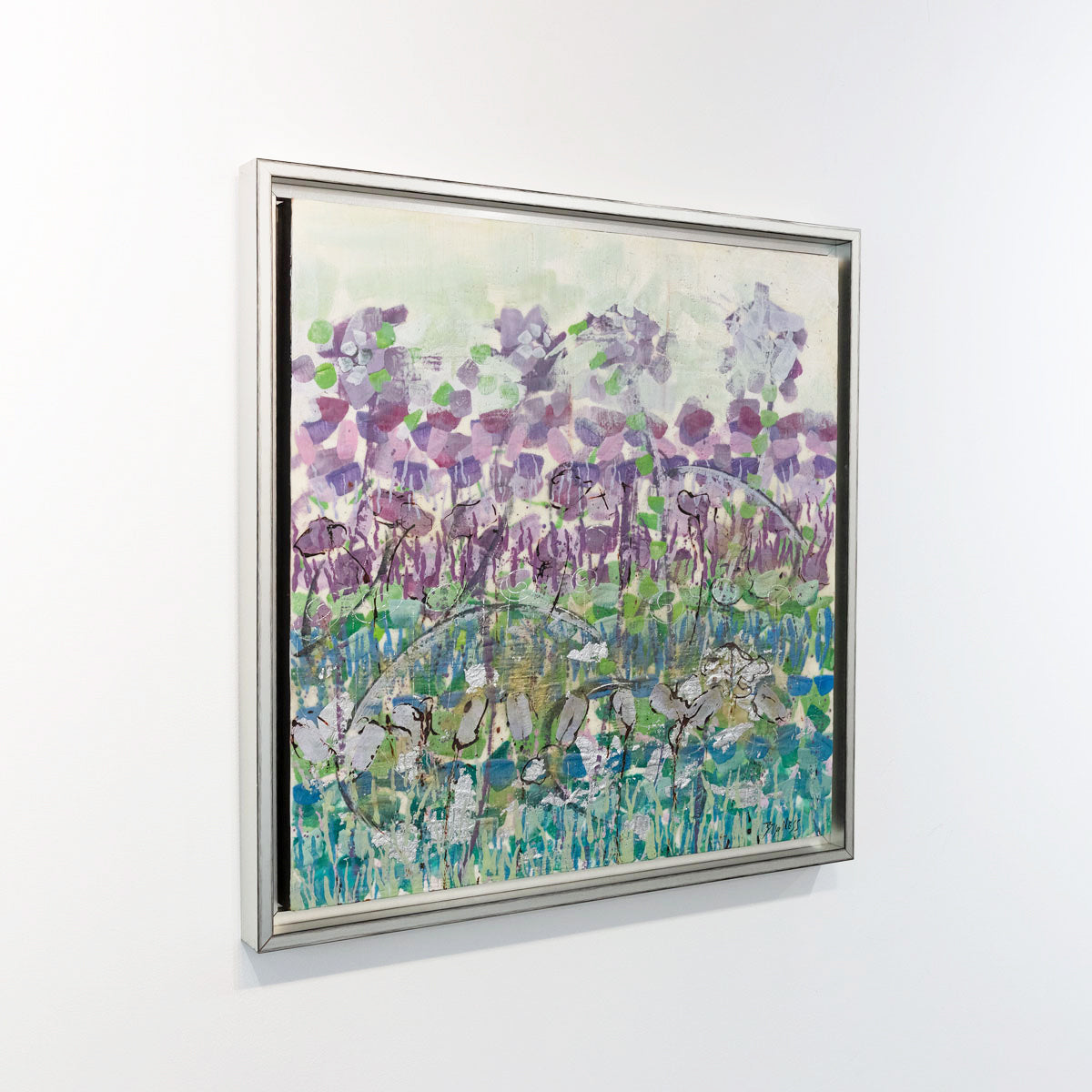 An abstract, encaustic floral painting of purple irises by Linda Bigness is seen at an angle on a gallery wall.