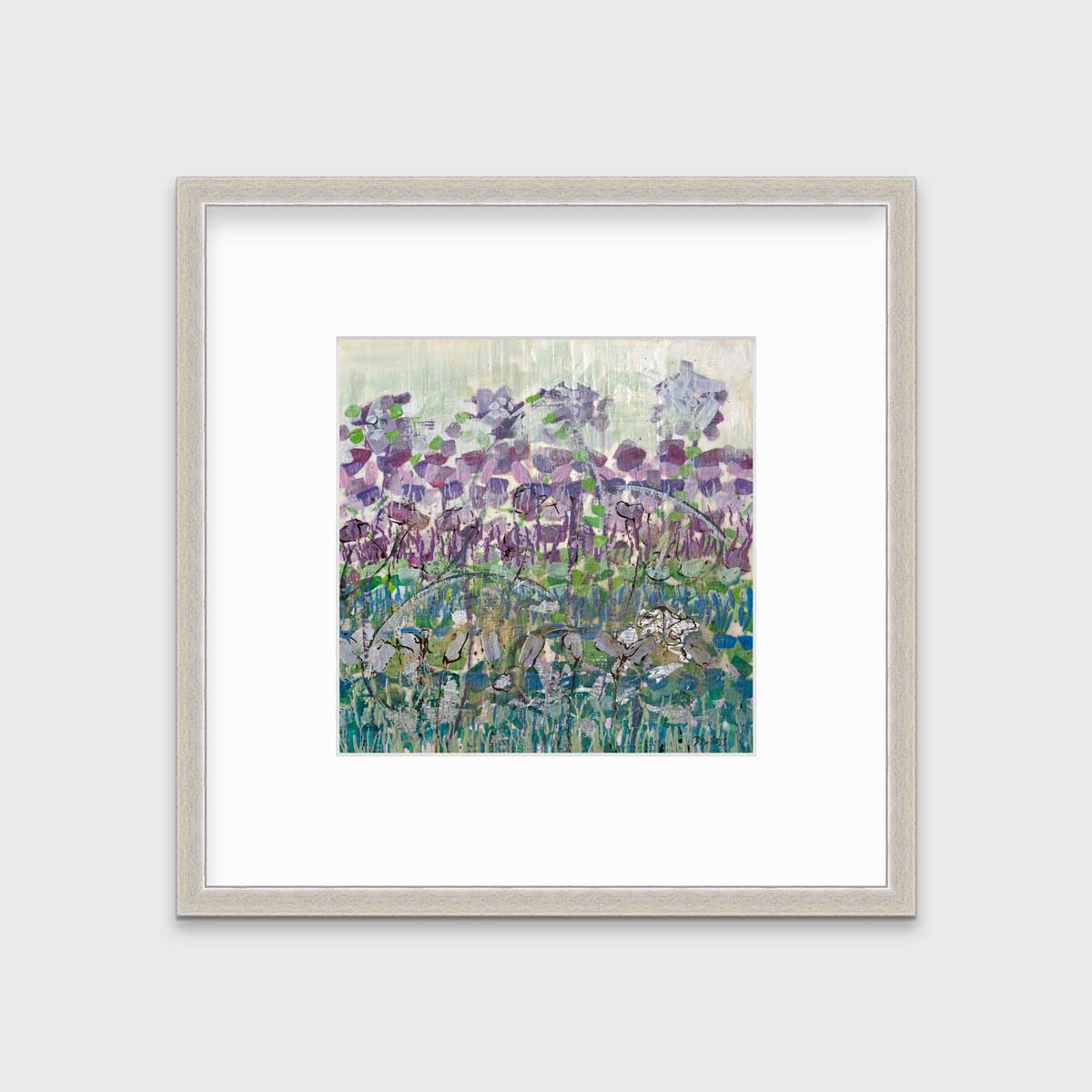 A purple, blue and green abstract floral print in a silver frame with a mat hangs on a white wall.
