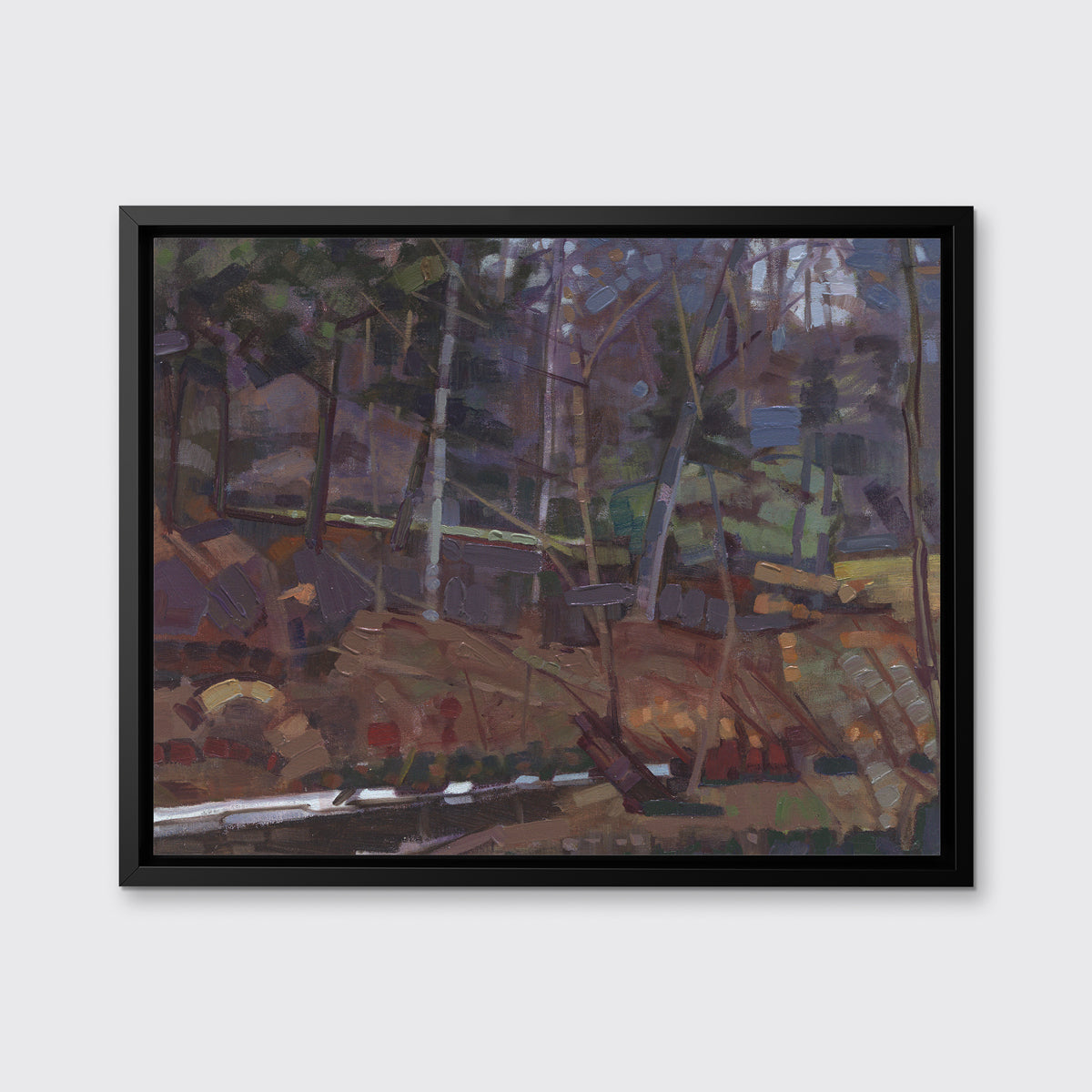 A brown, grey and green abstract landscape print in a black floater frame hangs on a white wall.
