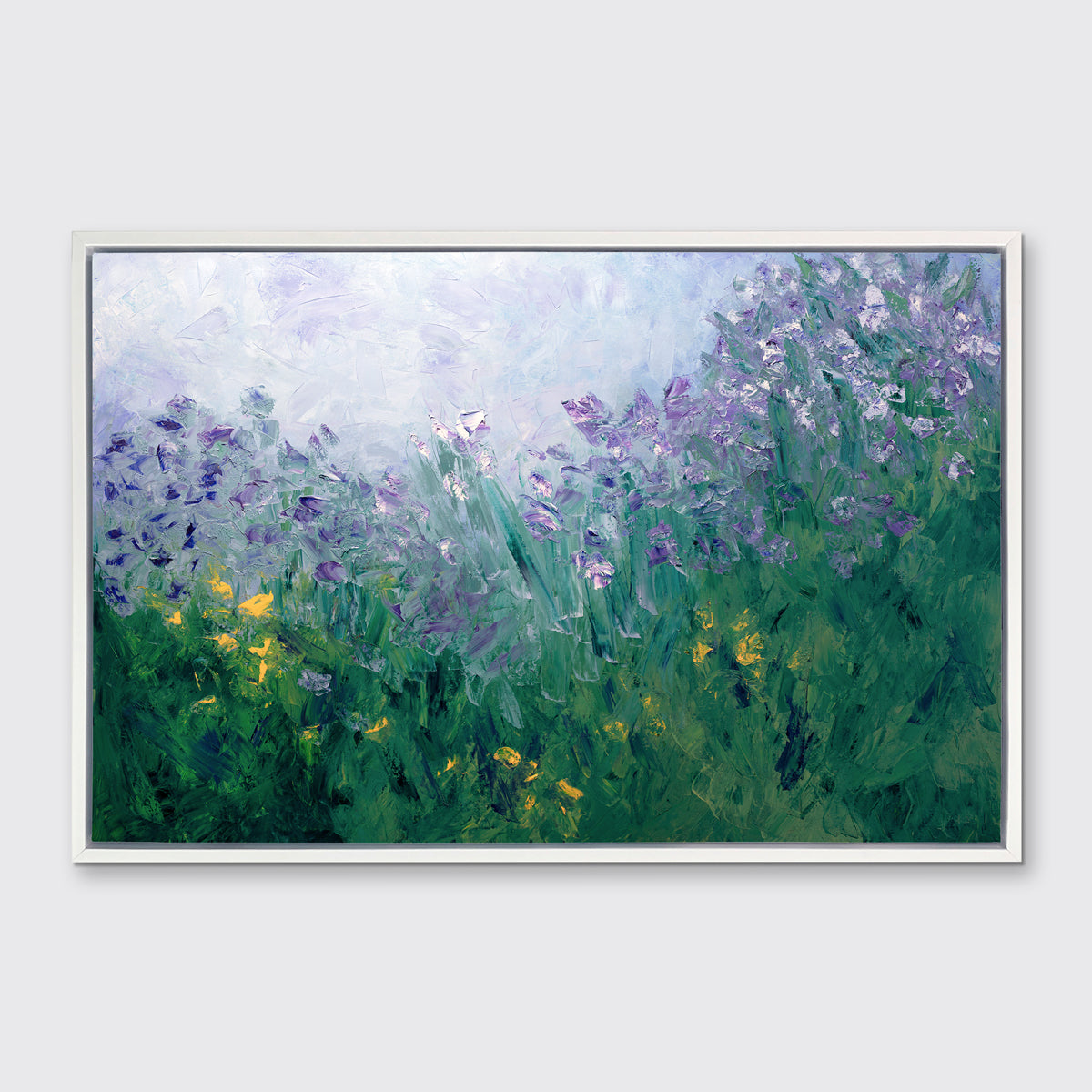 A blue, purple and green abstract print in a white floater frame hangs on a white wall.