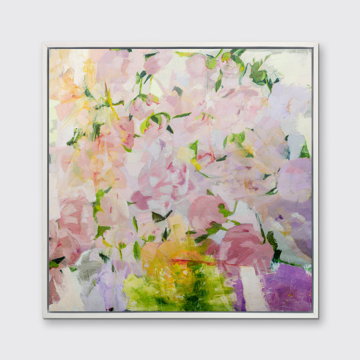 A multicolored floral abstract print in a white floater frame hangs on a white wall.
