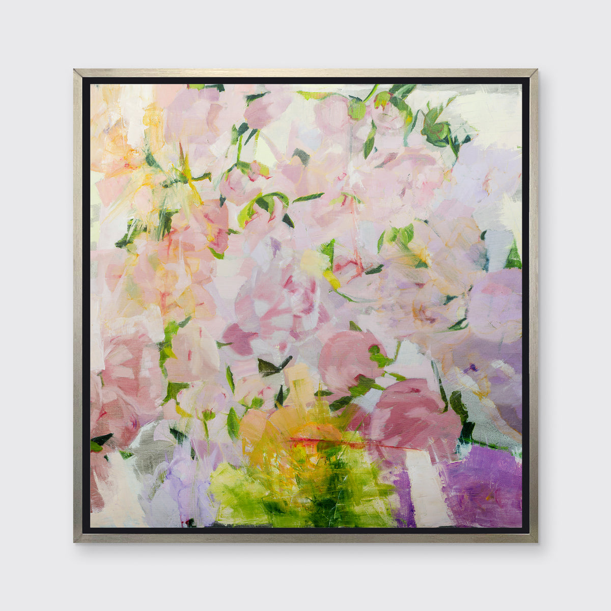 A multicolored floral abstract print in a silver floater frame hangs on a white wall.