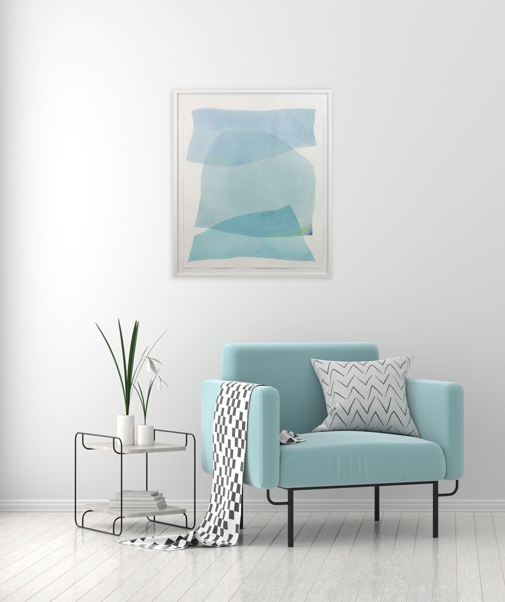 A watercolor painting of blue and turquoise stacked forms painted by Nealy Hauschildt hangs above a light blue armchair.
