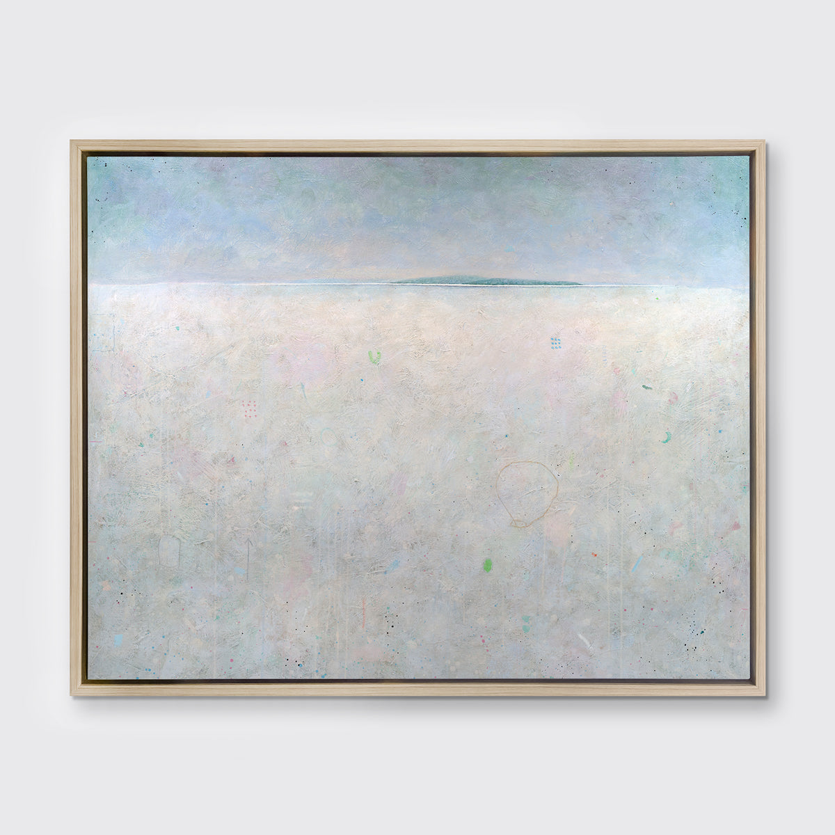 A light blue and white abstract landscape print in a white oak wood floater frame hangs on a white wall.