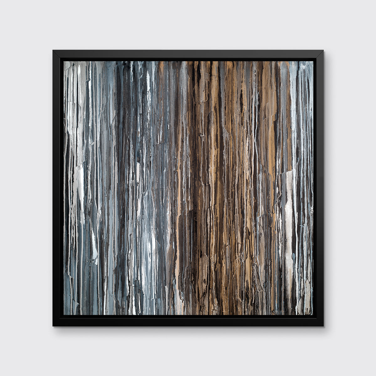 A brown, copper, white, grey and black abstract print in a black floater frame hangs on a white wall.
