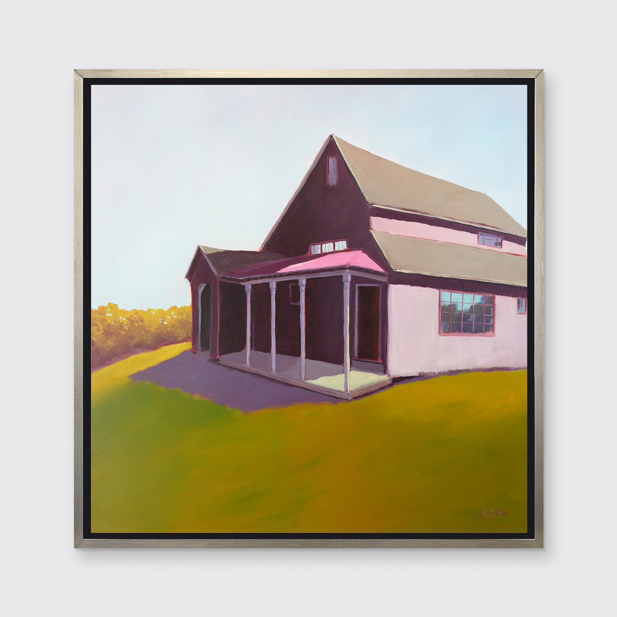 A raspberry, chartruse and light blue contemporary house print in a silver floater frame hangs on a white wall.