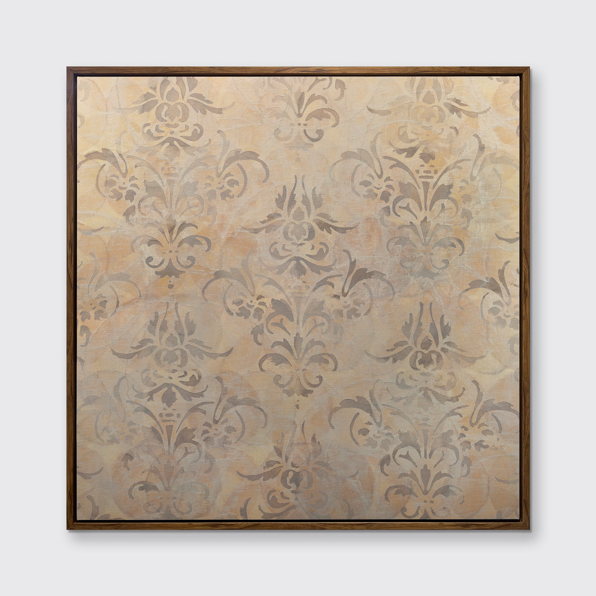 A light gold and silver abstract print in an oak wood floater frame hangs on a white wall.