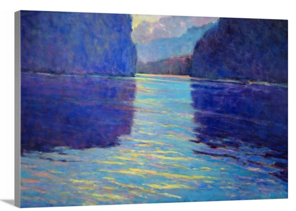 A side-angle view of a blue abstract landscape on canvas.
