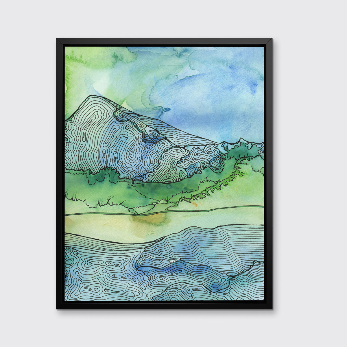 A green and blue landscape illustration framed in a black floater frame hangs on a light grey wall.