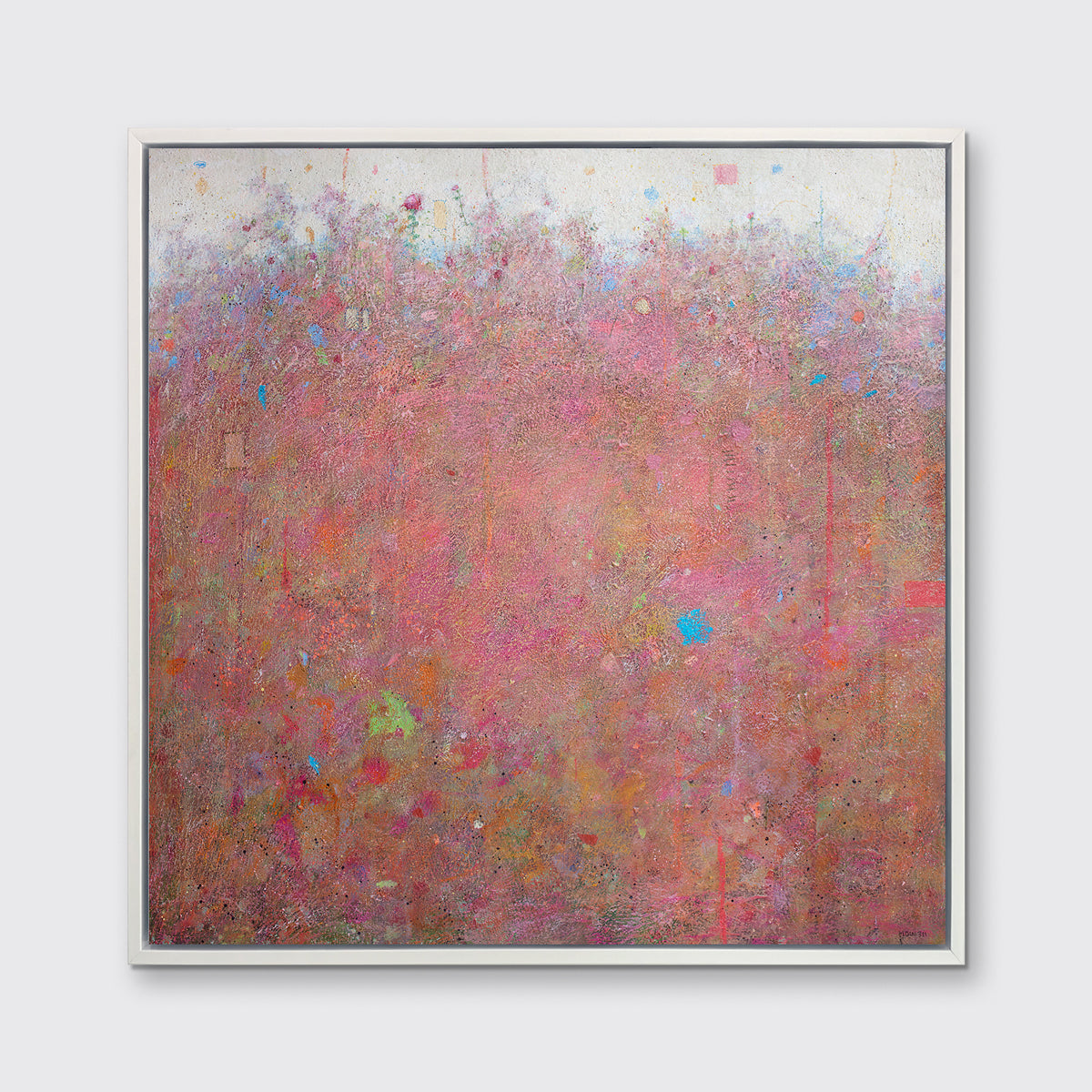 A red abstract landscape print in a white floater frame hangs on a white wall.