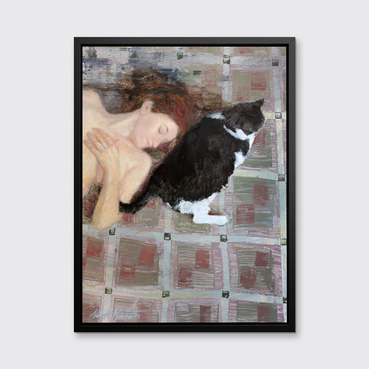 A print of a red-haired woman lays on a red and grey checkered floor next to a black and white cat in a black floater frame hangs on a white wall.