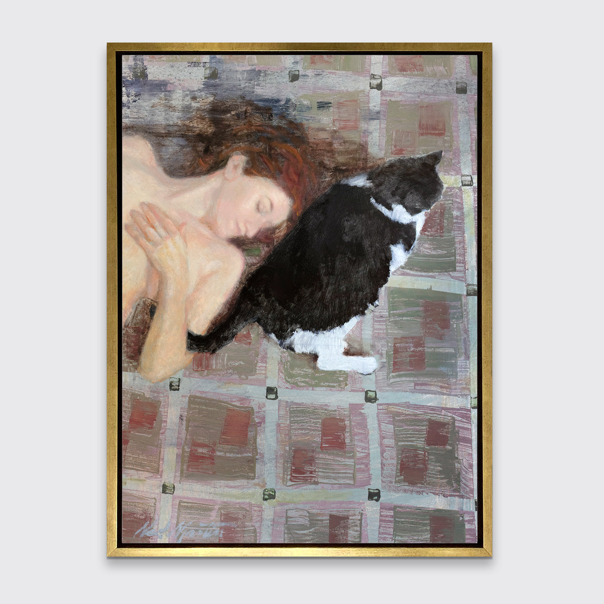 A print of a red-haired woman lays on a red and grey checkered floor next to a black and white cat in a gold floater frame hangs on a white wall.
