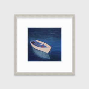 A blue, beige and lavender contemporary coastal print of a boat wading in the water in a silver frame with a mat hangs on a white wall.