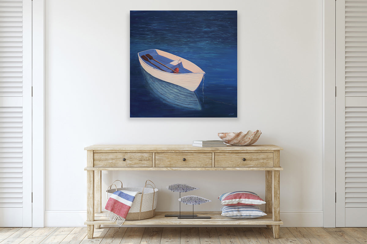 A painting of a white rowboat in deep blue water is hung above a console table.