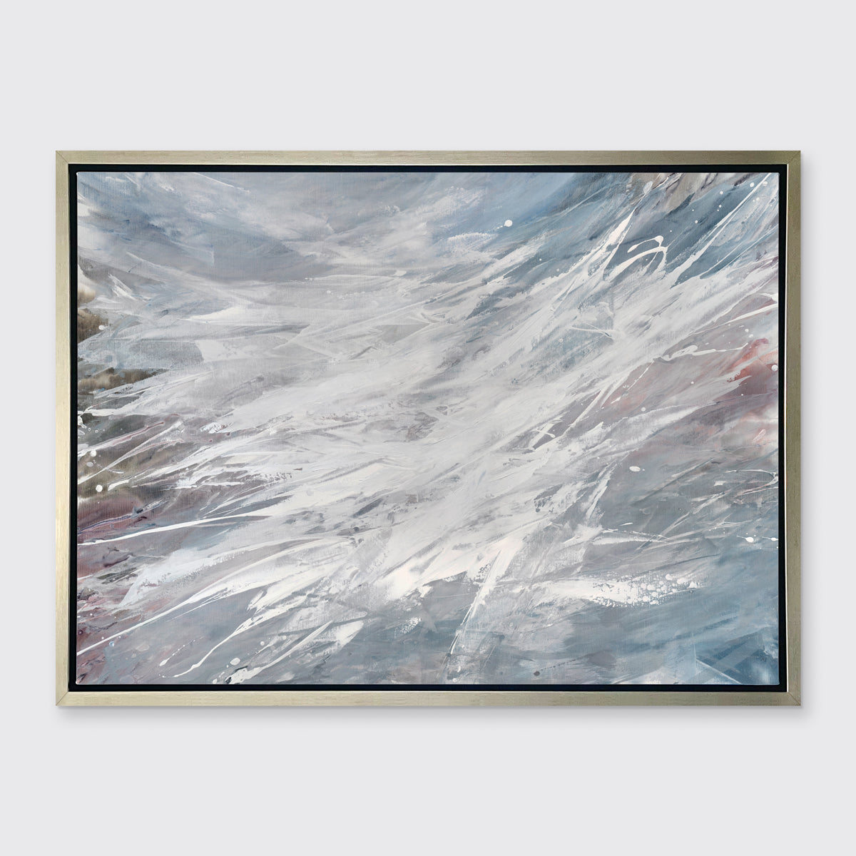 A grey, white and blue abstract print in a silver floater frame hangs on a white wall.