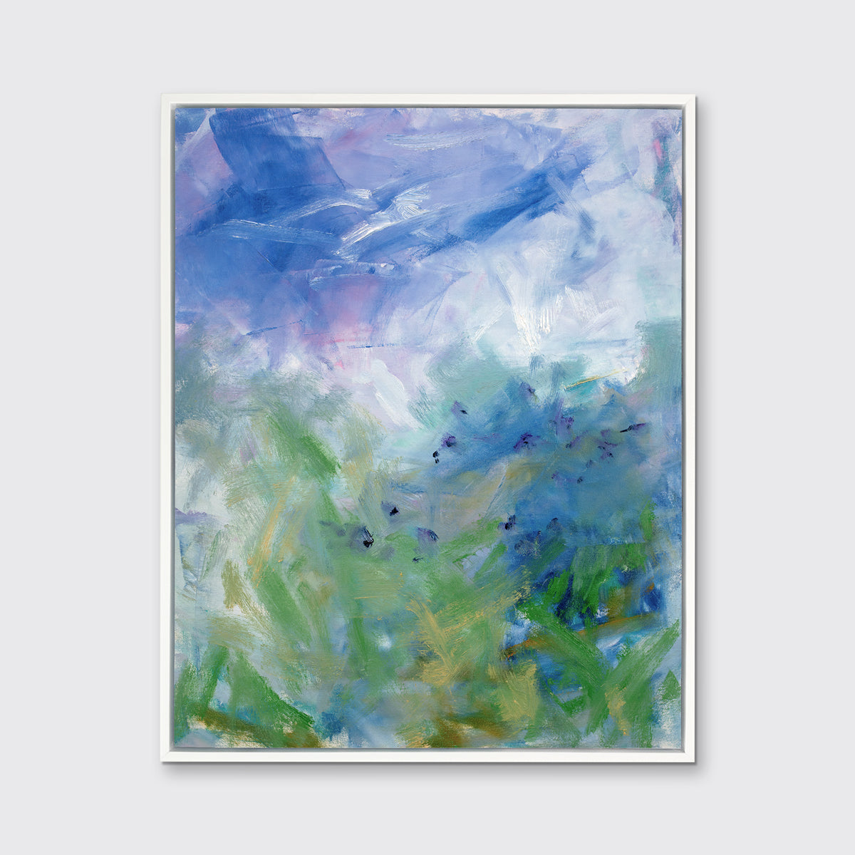 A blue, purple and green abstract print in a white floater frame hangs on a white wall.