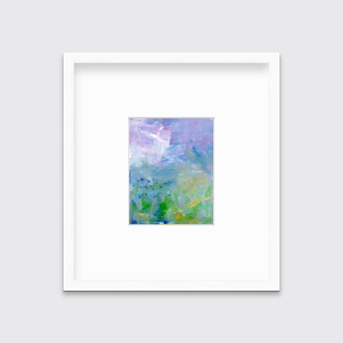 A blue, purple and green abstract print in a white frame with a mat hangs on a white wall.