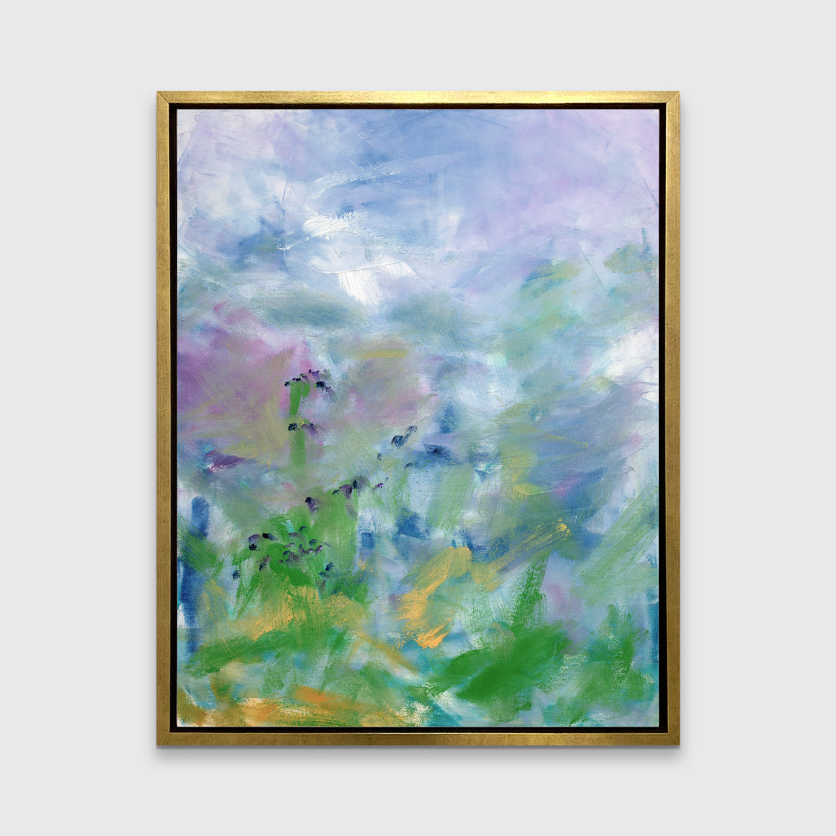 A blue, purple and green abstract print in a gold floater frame hangs on a white wall.