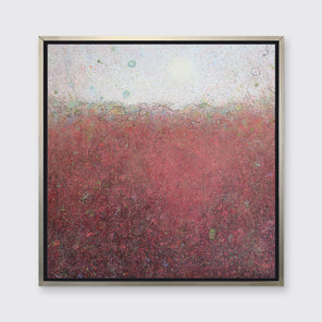A red abstract landscape print in a silver floater frame hangs on a white wall.