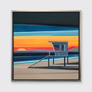 A multicolored geometric abstract of a lifeguard station at sunset in a silver floater frame hangs on a white wall.