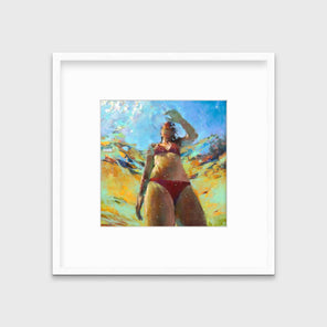 An abstract figurative print of a woman underwater in a red bikini, hangs in a white frame with a mat on a white wall.