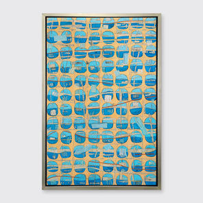 An orange, blue and light blue abstract print in a silver floater frame hangs on a white wall.
