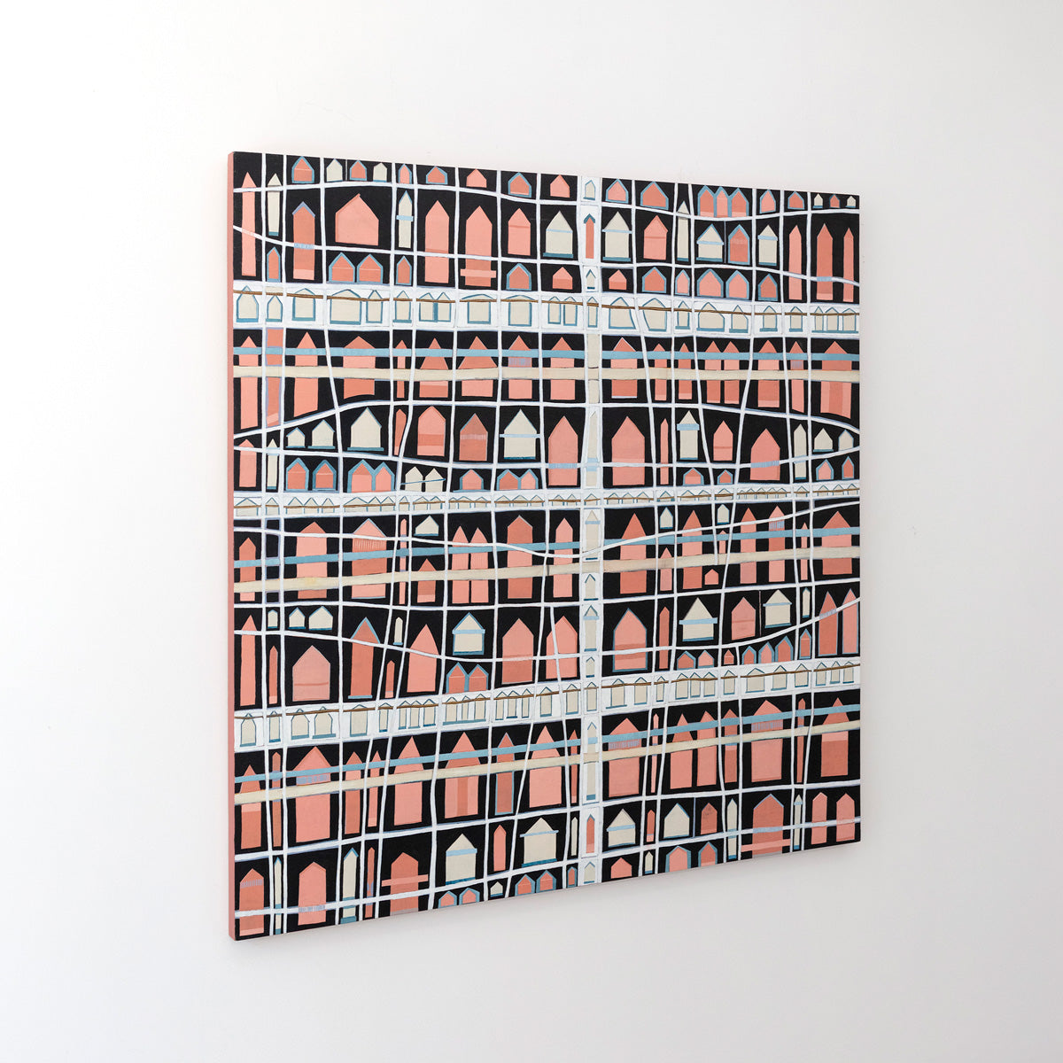 An abstract painting with cross hatching brushstrokes over small pink house shapes is seen at an angle on a gallery wall.