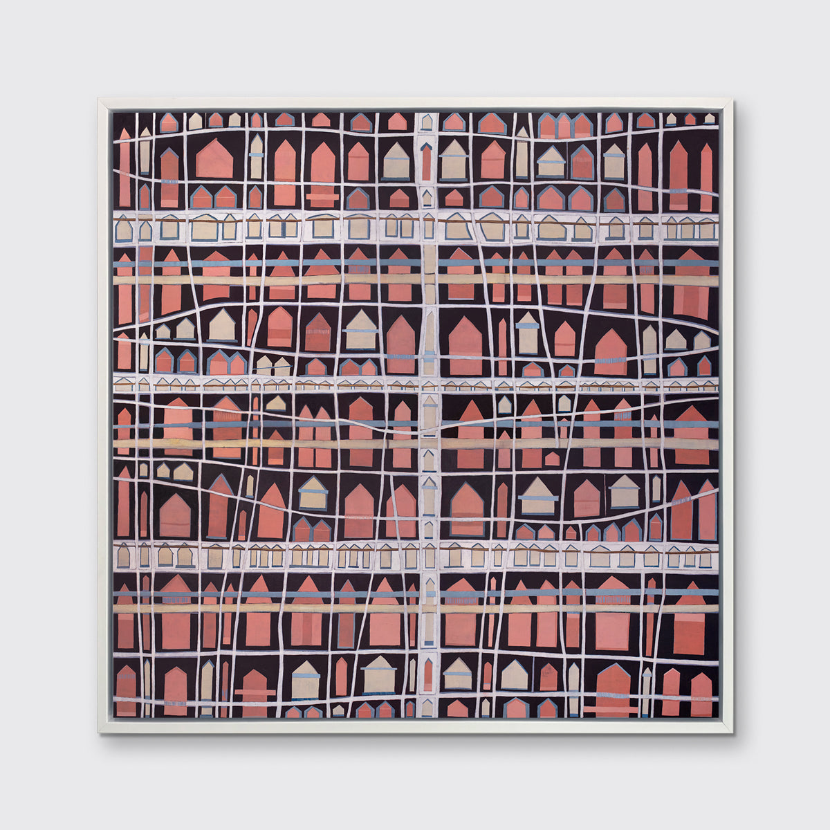 A pink, white and black abstract house print in a white floater frame hangs on a white wall.