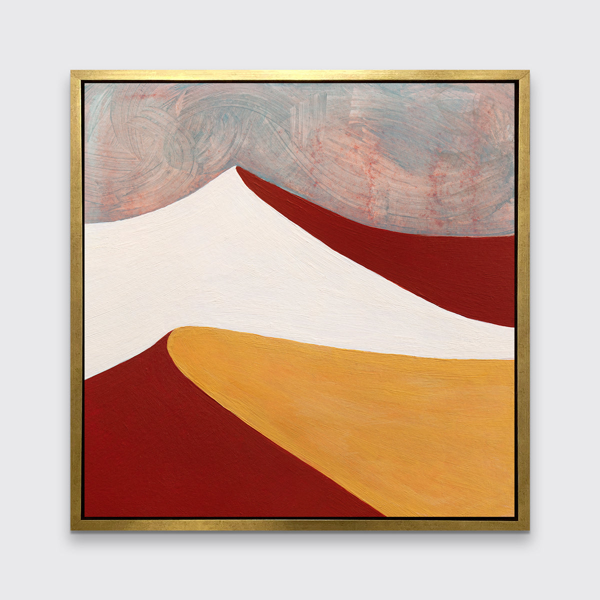 A dark red, white, dark yellow and teal abstract landscape print in a gold floater frame hangs on a white wall.