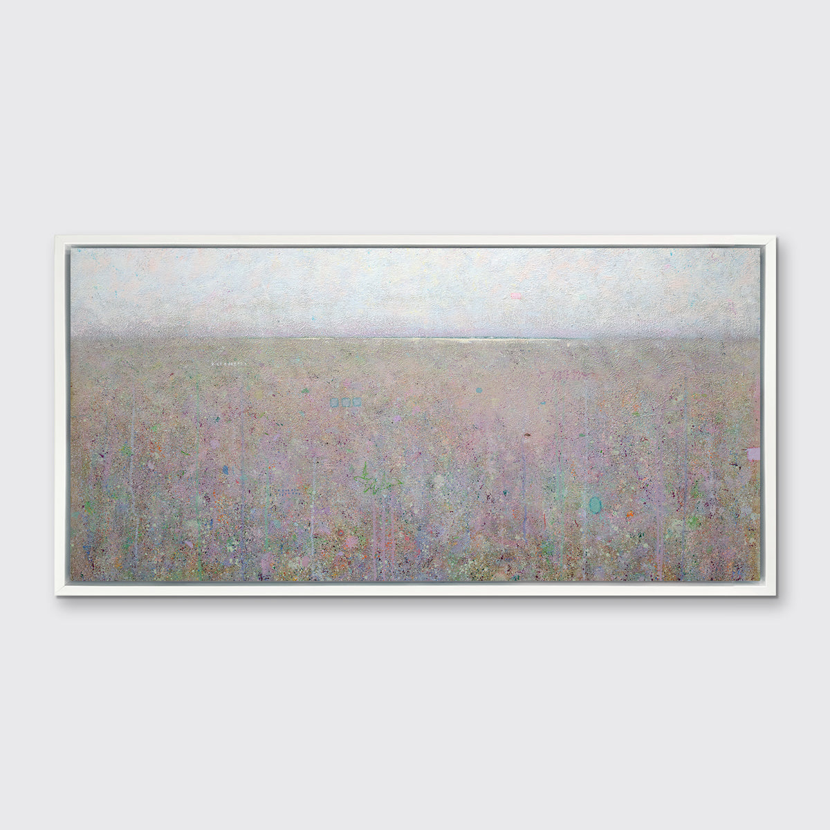 A muted green abstract landscape print in a white floater frame hangs on a white wall.
